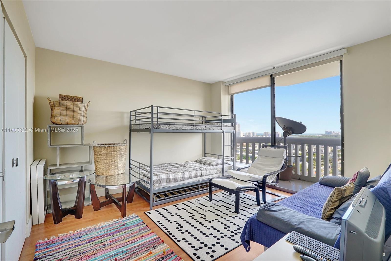 1000 East Island Boulevard, Unit 2004 Aventura, FL 33160 - Photo 30 of 45 a bedroom with furniture and a rug