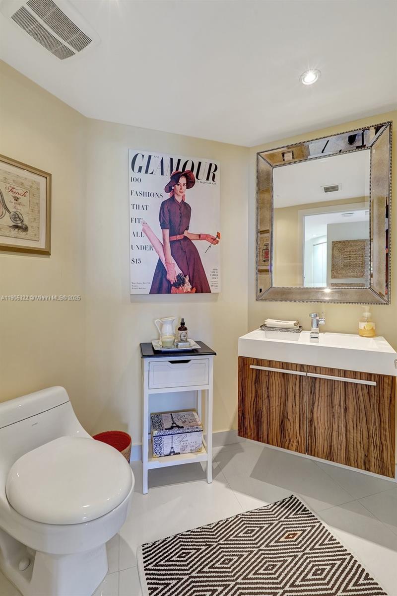 1000 East Island Boulevard, Unit 2004 Aventura, FL 33160 - Photo 32 of 45 a spacious bathroom with a toilet a sink and a mirror