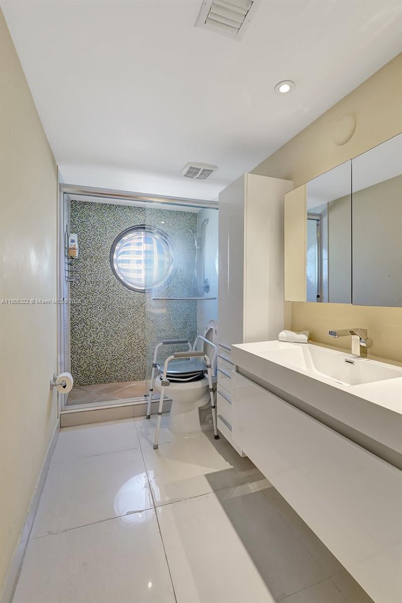 1000 East Island Boulevard, Unit 2004 Aventura, FL 33160 - Photo 33 of 45 a spacious bathroom with a tub sink and mirror