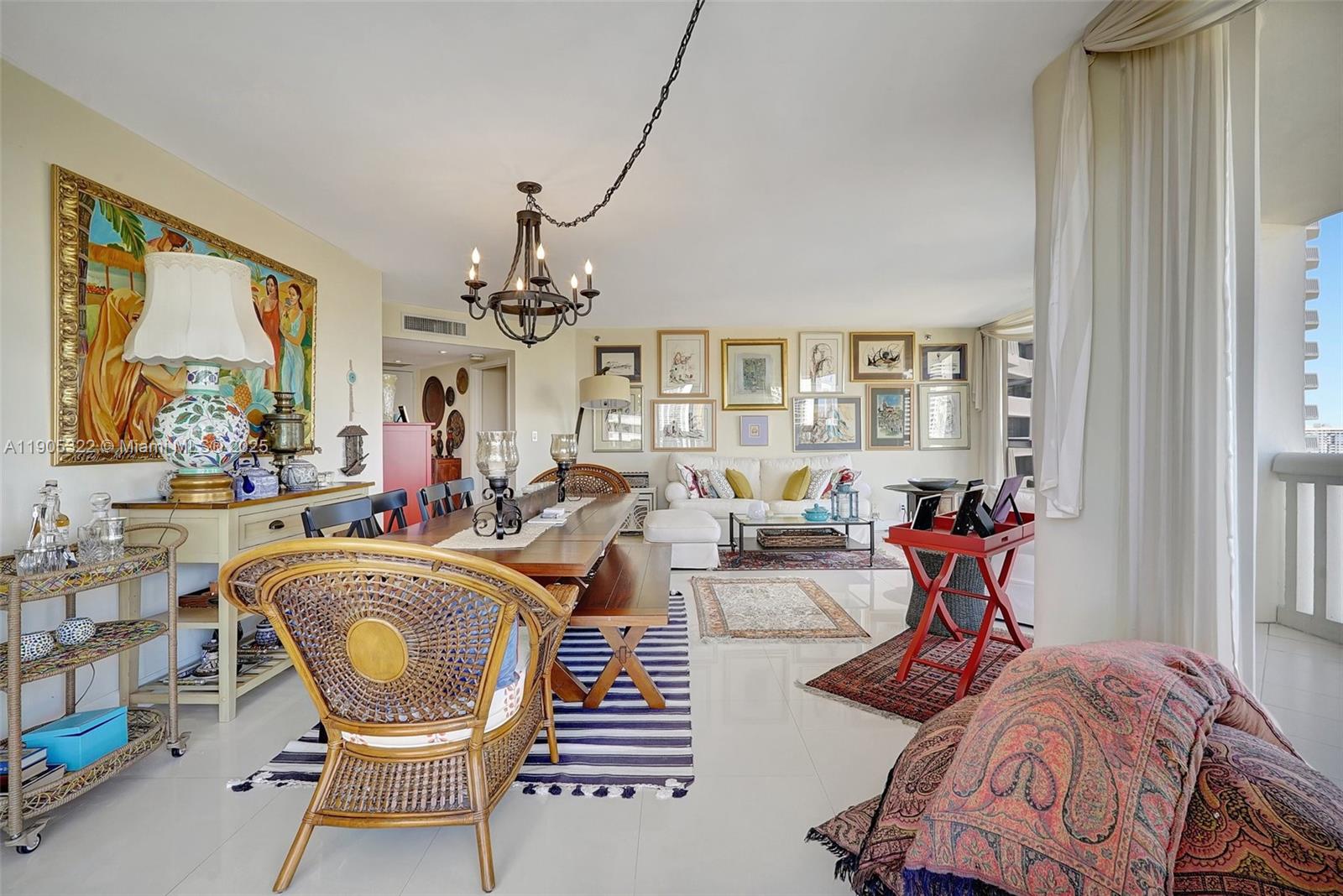 1000 East Island Boulevard, Unit 2004 Aventura, FL 33160 - Photo 7 of 45 a living room with furniture a chandelier and a large window