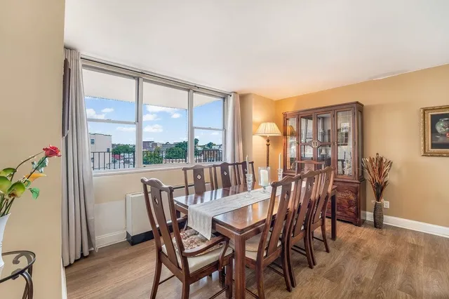 a view of a dining room with furniture window and wooden floor