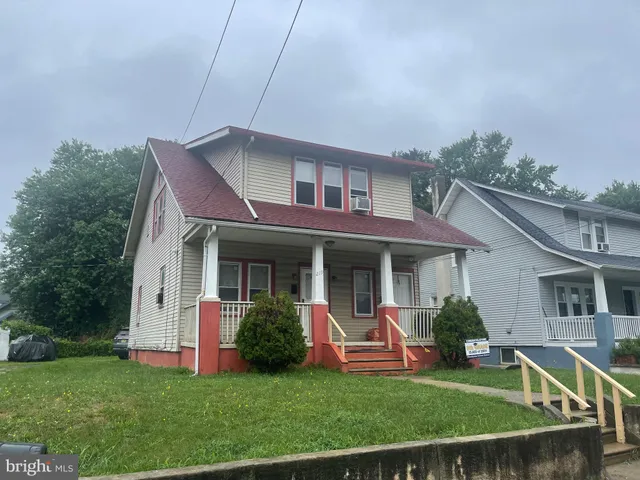 a view of a house with a yard porch and sitting area