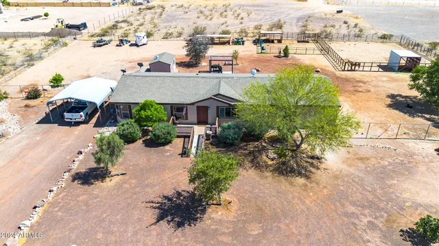 an aerial view of a house with garden space and a street view