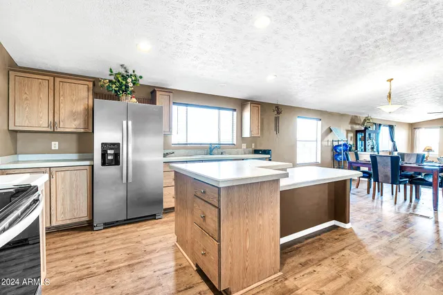 a kitchen with stainless steel appliances granite countertop a stove and a refrigerator