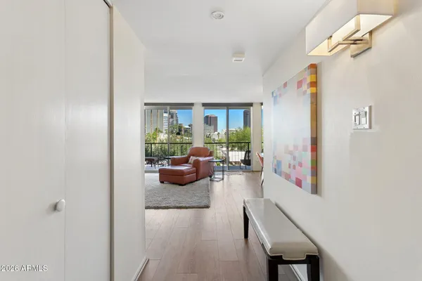 a living room with furniture and a wooden floor