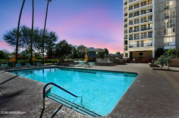 a view of swimming pool with outdoor seating and plants