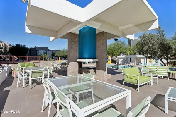 a swimming pool with outdoor seating and yard