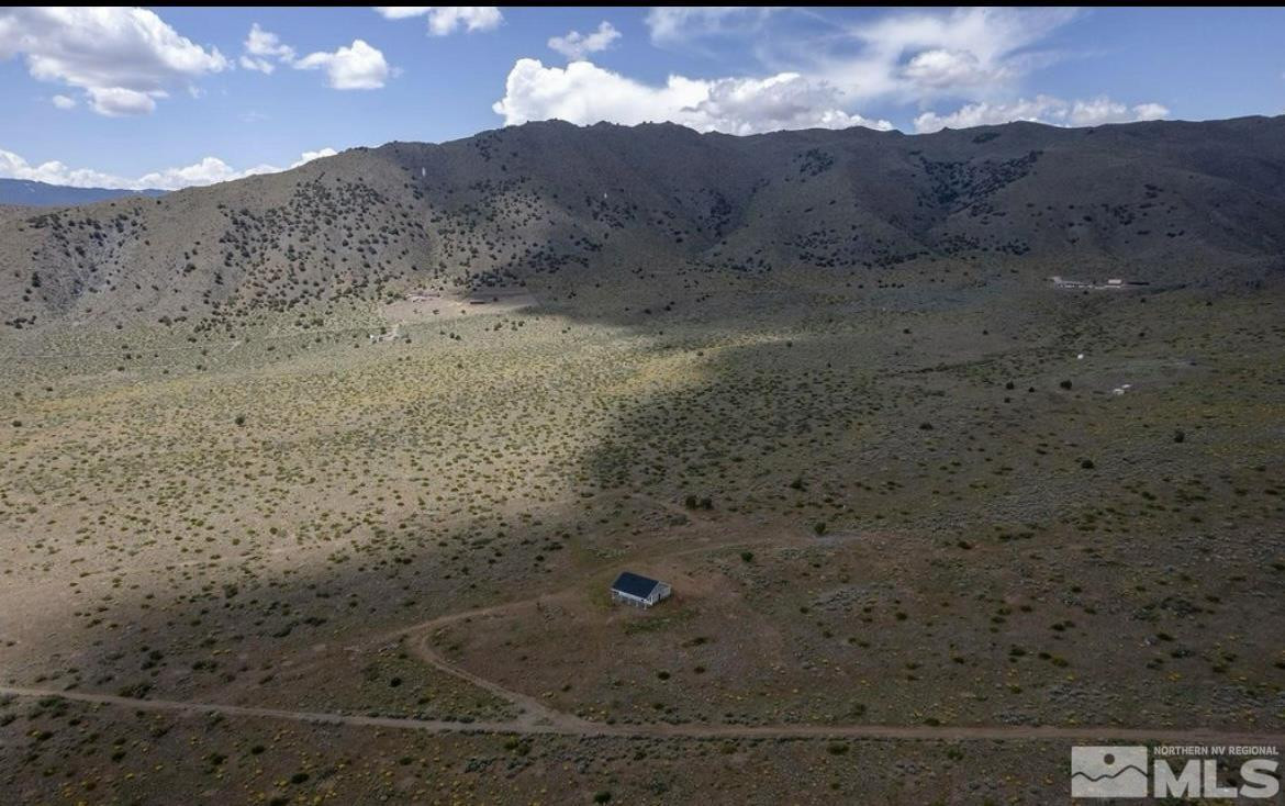 1300 Freds Mountain Road Reno, NV 89508 - Photo 11 of 24 a view of a dry yard with mountains in the background