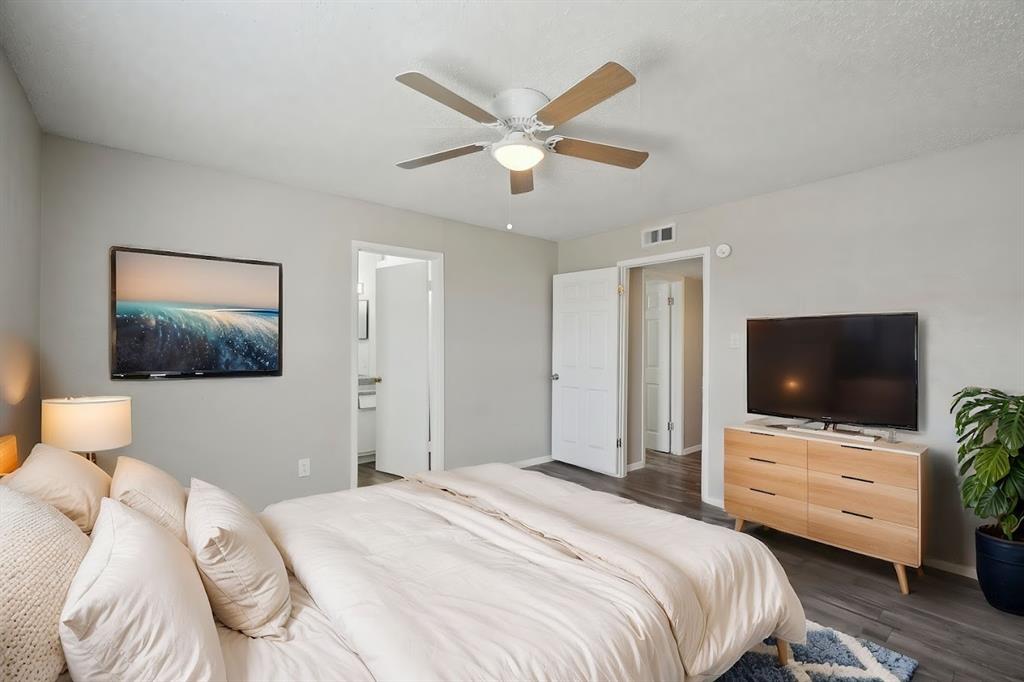 306 Vine Street, Unit B Euless, TX 76040 - Photo 2 of 6 a bedroom with a bed and a flat screen tv
