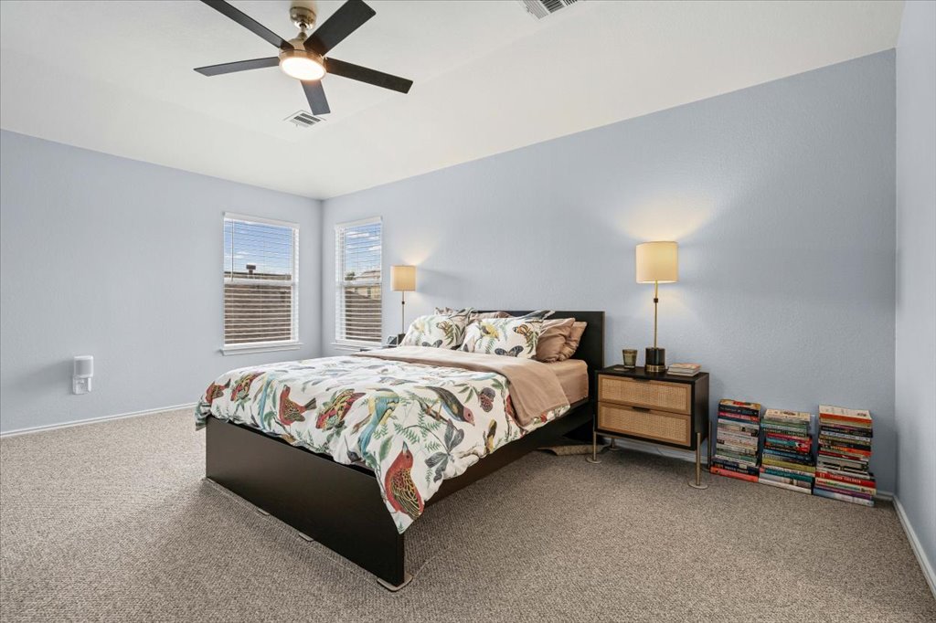 501 Sampson Kyle, TX 78640 - Photo 17 of 31 a bedroom with a bed and a lamp on the dresser