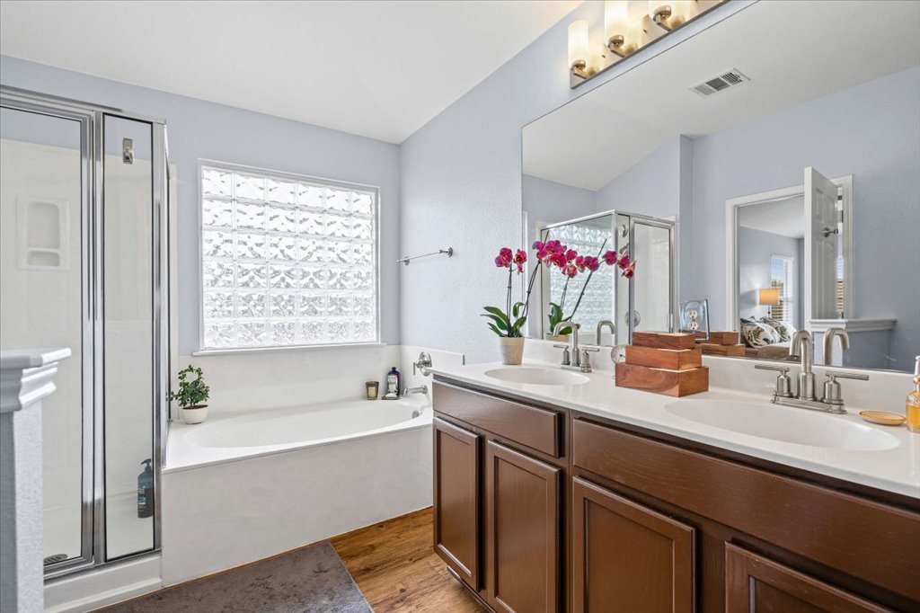 501 Sampson Kyle, TX 78640 - Photo 18 of 31 a bathroom with a tub sink and mirror