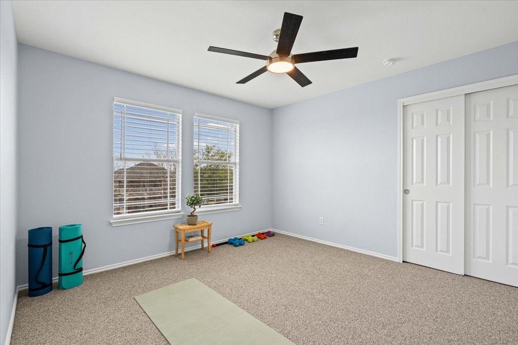 501 Sampson Kyle, TX 78640 - Photo 21 of 31 a living room with a window and a ceiling fan