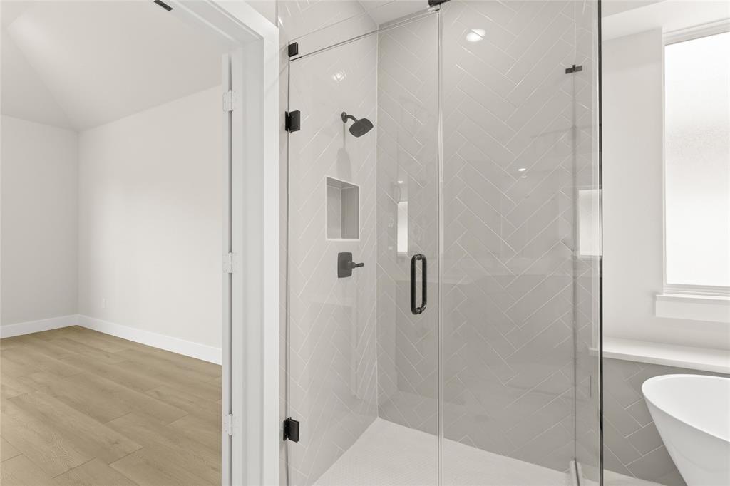 1328 Cash Street Burleson, TX 76028 - Photo 29 of 39 Bathroom with baseboards, a freestanding bath, a stall shower, and wood finished floors