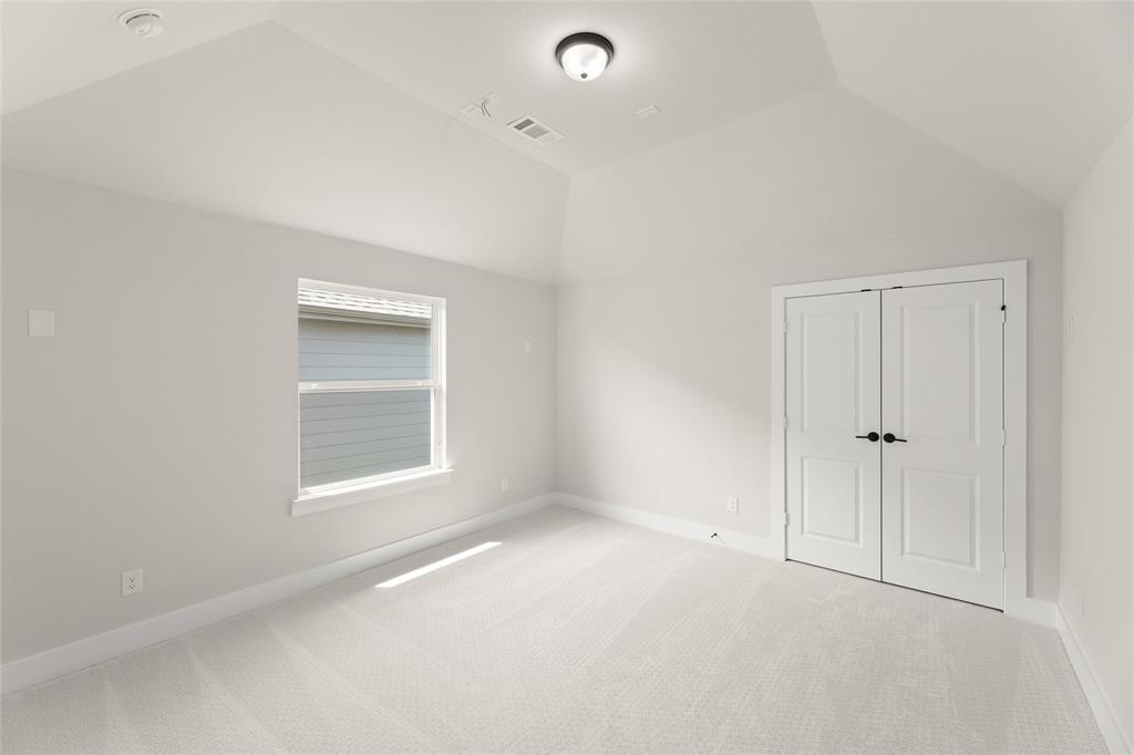 1328 Cash Street Burleson, TX 76028 - Photo 34 of 39 Unfurnished bedroom featuring baseboards, a closet, vaulted ceiling, visible vents, and carpet