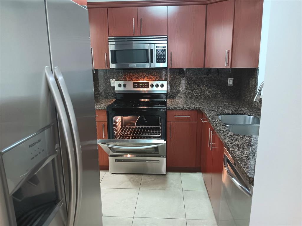 a kitchen with a refrigerator stove and microwave