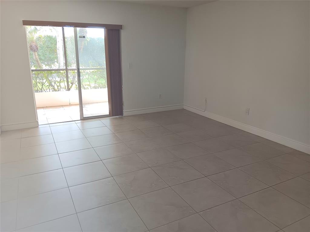 1265 Southwest 46th Avenue, Unit 2207 Pompano Beach, FL 33069 - Photo 14 of 33 a view of an empty room and window