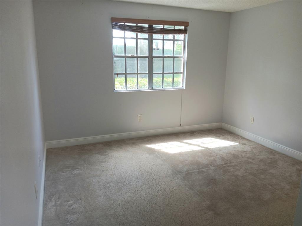 1265 Southwest 46th Avenue, Unit 2207 Pompano Beach, FL 33069 - Photo 24 of 33 an empty room with a window