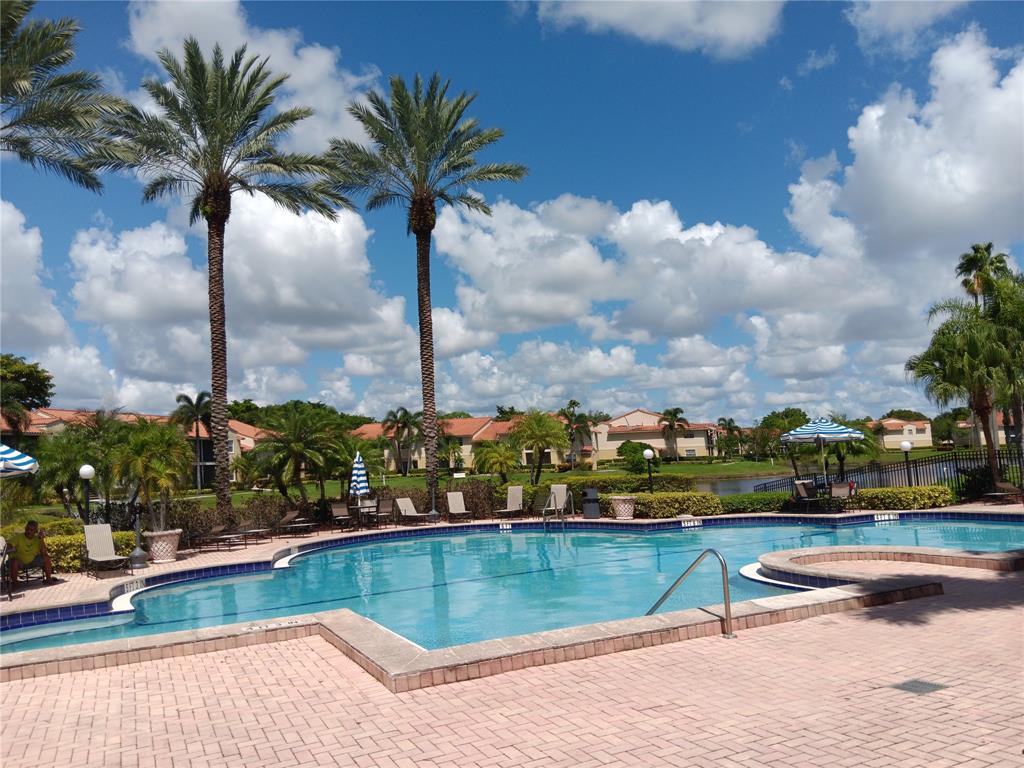 1265 Southwest 46th Avenue, Unit 2207 Pompano Beach, FL 33069 - Photo 30 of 33 a view of swimming pool with outdoor seating and city view
