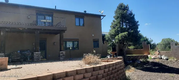 a view of a backyard with table and chairs