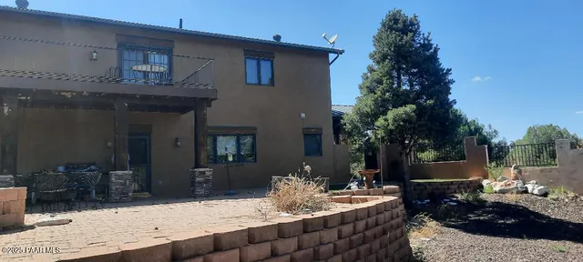 a view of a backyard with table and chairs