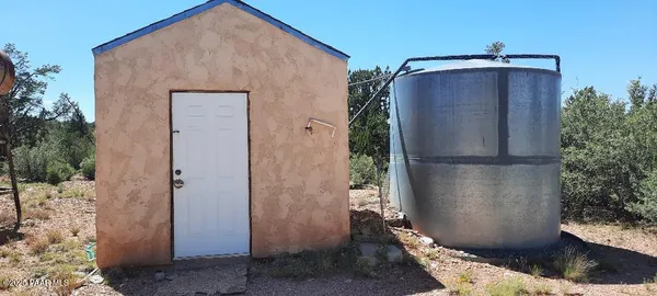 a view of a chairs and table in the backyard
