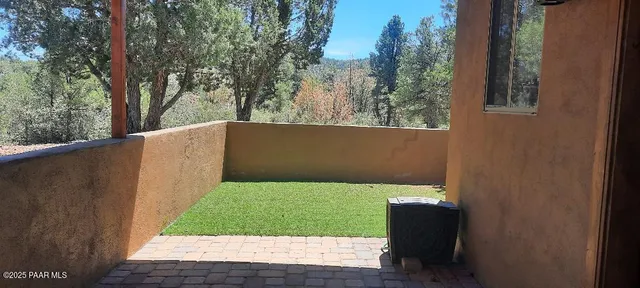a kitchen with a table chairs and refrigerator in it