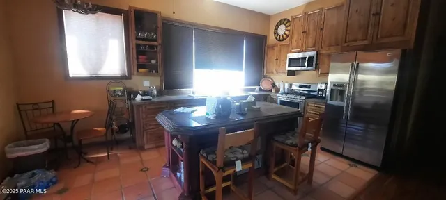 a bed sitting in a bedroom next to a small bathroom