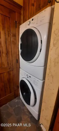 a living room with furniture and a book shelf