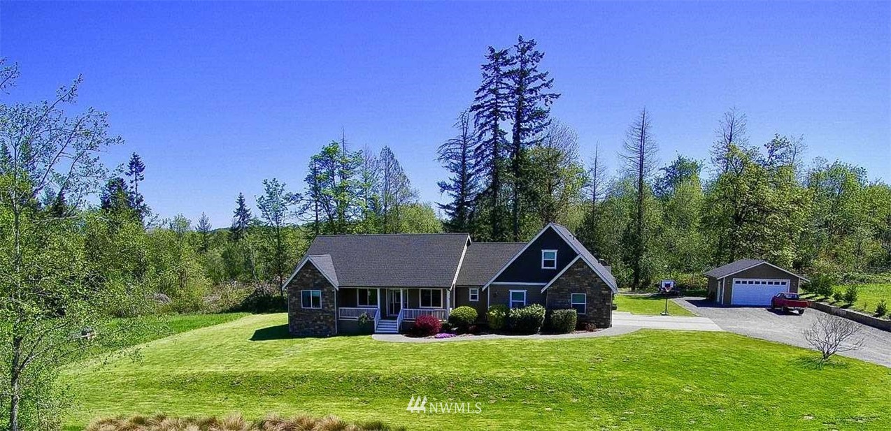 a front view of a house with yard and green space