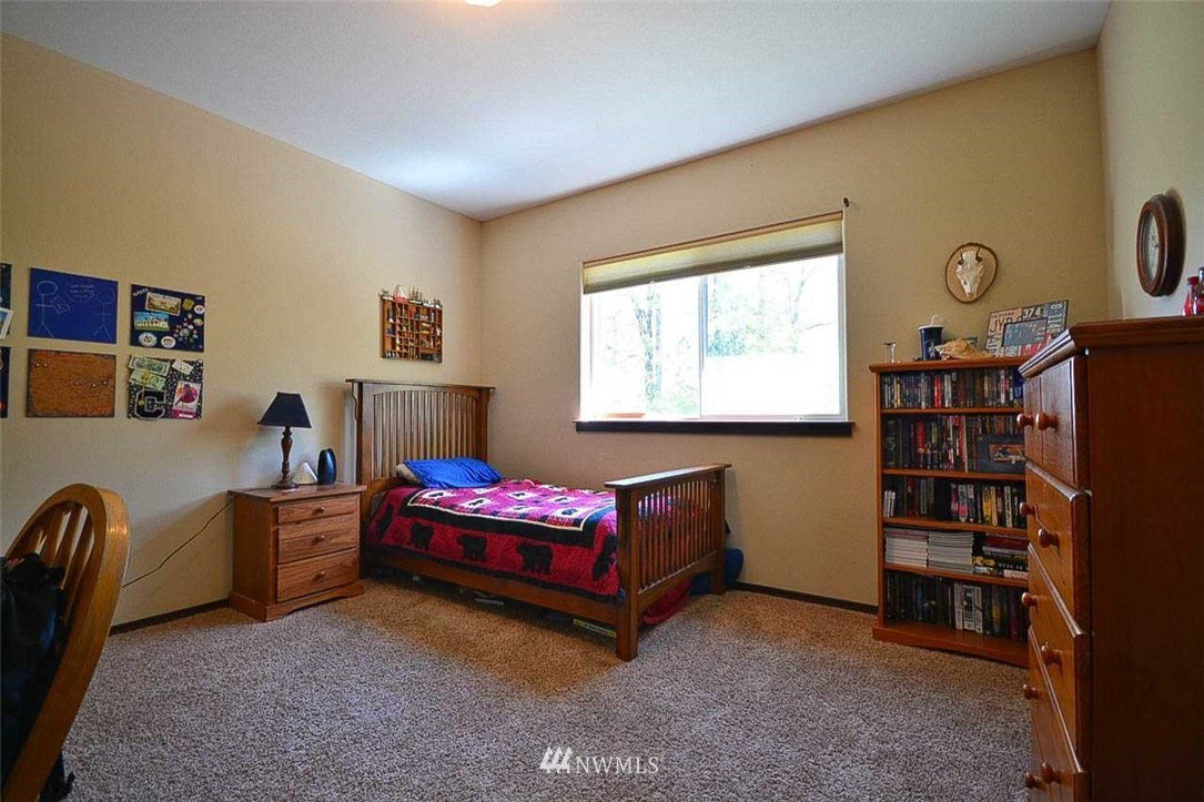 19930 Bear View Lane Southwest Rochester, WA 98579 - Photo 11 of 25 a living room with furniture and a flat screen tv