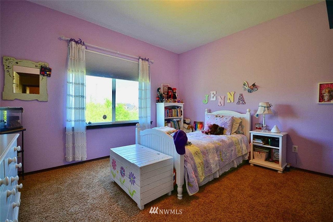 19930 Bear View Lane Southwest Rochester, WA 98579 - Photo 12 of 25 a bed room with a bed and a desk