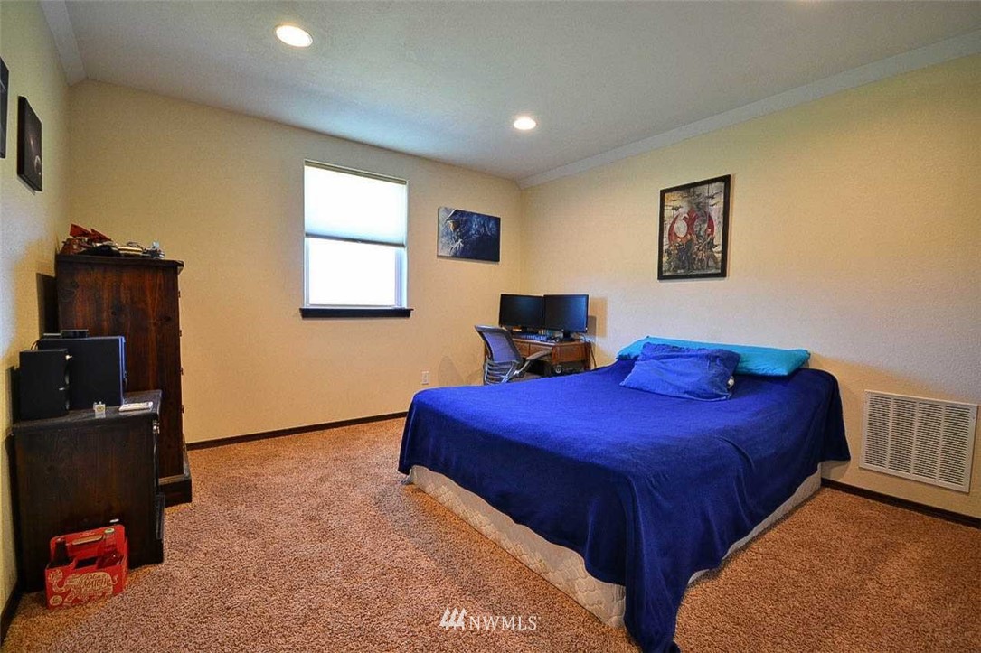 19930 Bear View Lane Southwest Rochester, WA 98579 - Photo 15 of 25 a bedroom with bed and wooden floor