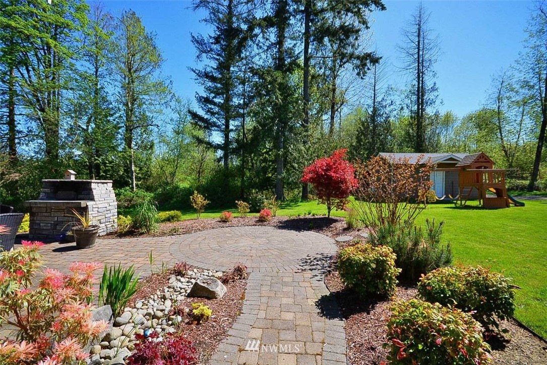 19930 Bear View Lane Southwest Rochester, WA 98579 - Photo 20 of 25 a front view of a house with a yard and outdoor seating