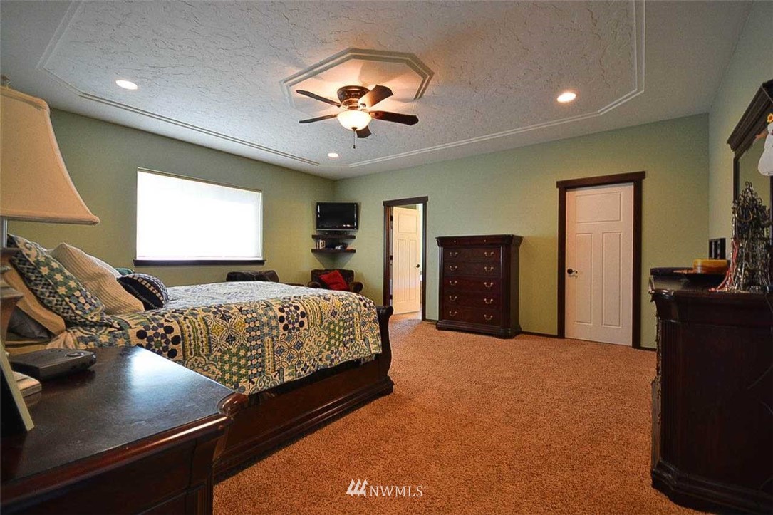 19930 Bear View Lane Southwest Rochester, WA 98579 - Photo 8 of 25 a bedroom with a bed and a chandelier