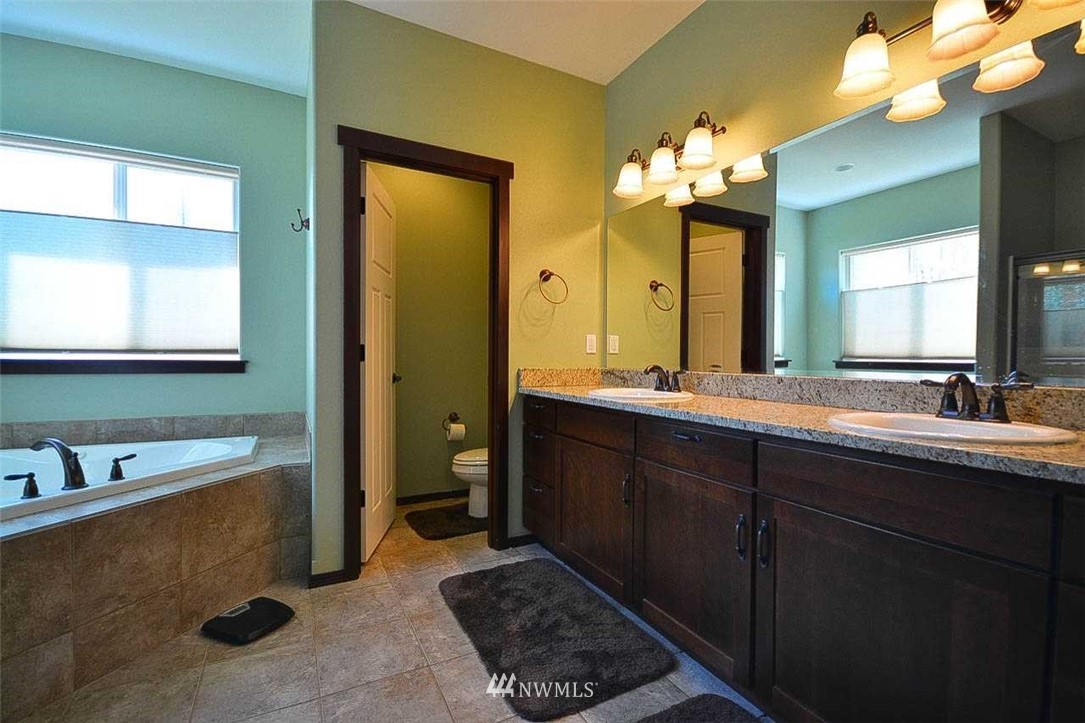 19930 Bear View Lane Southwest Rochester, WA 98579 - Photo 9 of 25 a bathroom with a tub a sink and a mirror