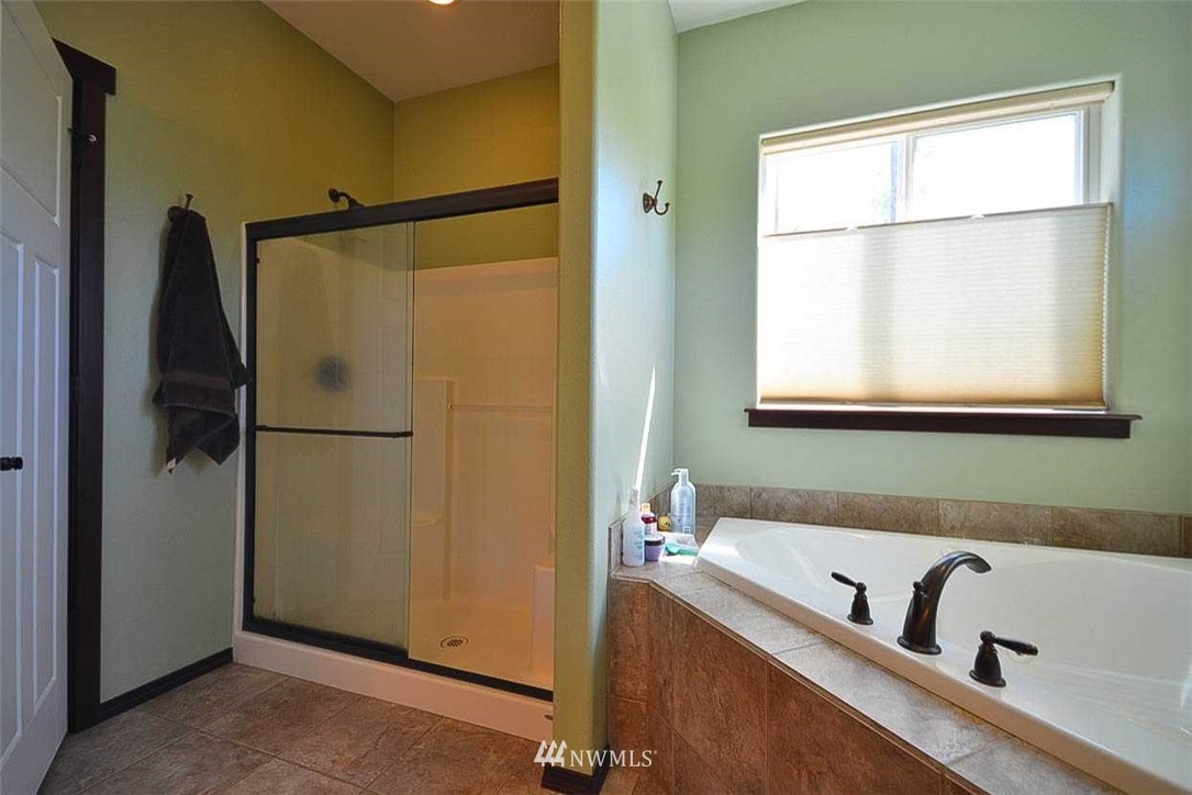 19930 Bear View Lane Southwest Rochester, WA 98579 - Photo 10 of 25 a bathroom with a bathtub and a shower