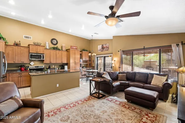 a living room with furniture and kitchen view