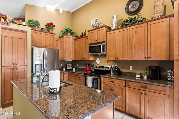 a kitchen with stainless steel appliances granite countertop a sink dishwasher stove top oven and microwave