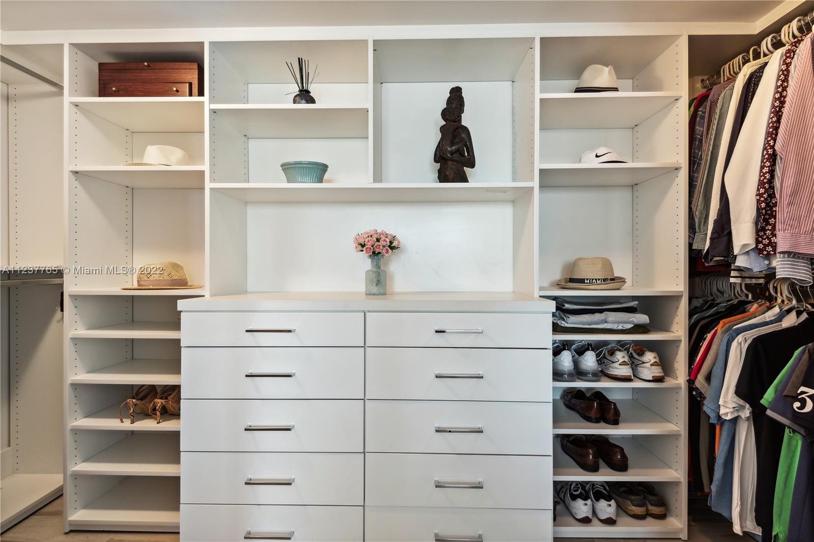 90 Alton Road, Unit TH8 Miami Beach, FL 33139 - Photo 11 of 25 a view of walk in closet with clothes and shoes