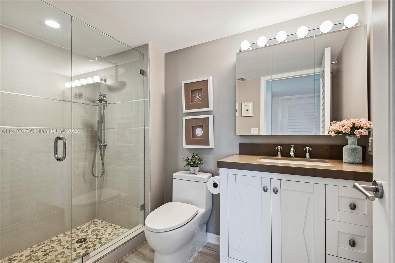 90 Alton Road, Unit TH8 Miami Beach, FL 33139 - Photo 15 of 25 a bathroom with a sink a toilet and shower