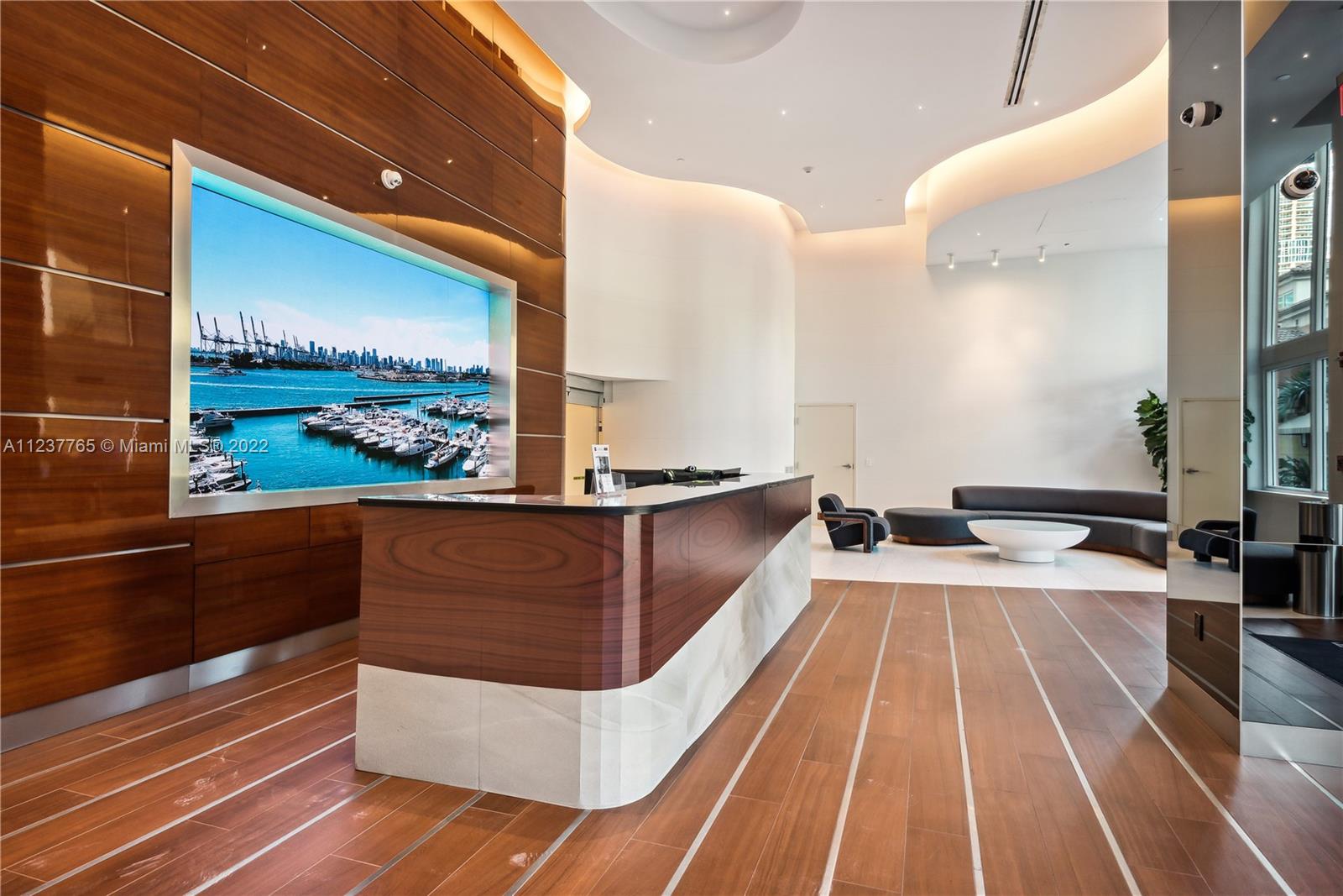 90 Alton Road, Unit TH8 Miami Beach, FL 33139 - Photo 22 of 25 a view of a living room and kitchen with furniture