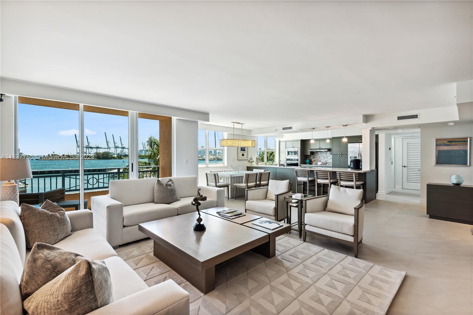 90 Alton Road, Unit TH8 Miami Beach, FL 33139 - Photo 3 of 25 a living room with furniture and a large window