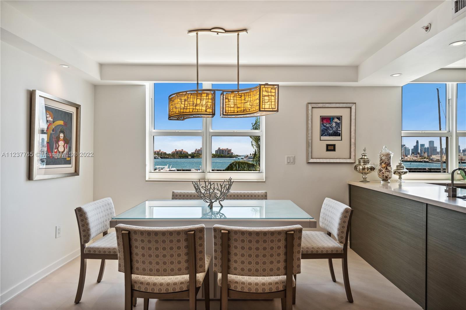 90 Alton Road, Unit TH8 Miami Beach, FL 33139 - Photo 5 of 25 a dining room with furniture and window