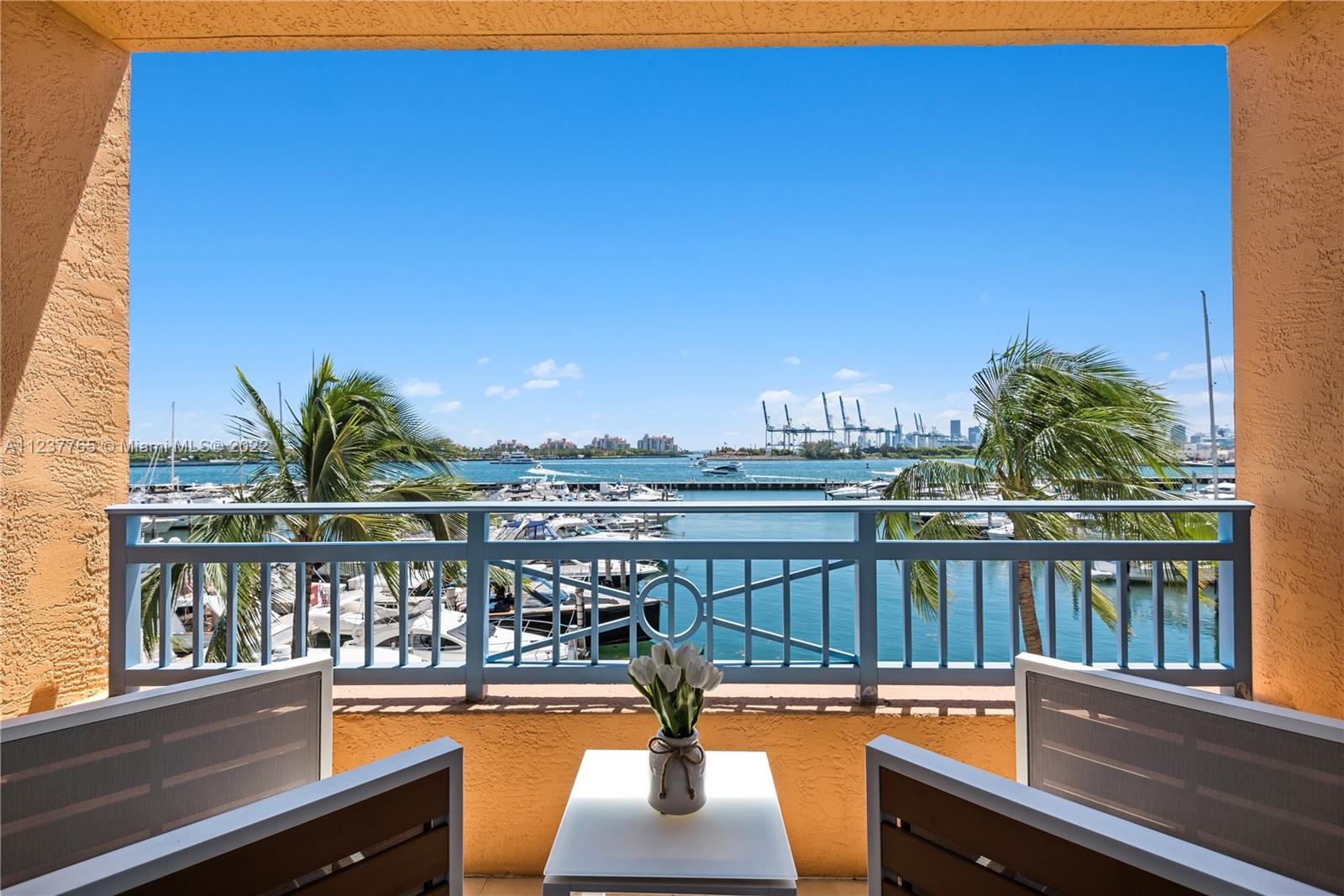 90 Alton Road, Unit TH8 Miami Beach, FL 33139 - Photo 7 of 25 a view of a balcony with lake view and wooden floor