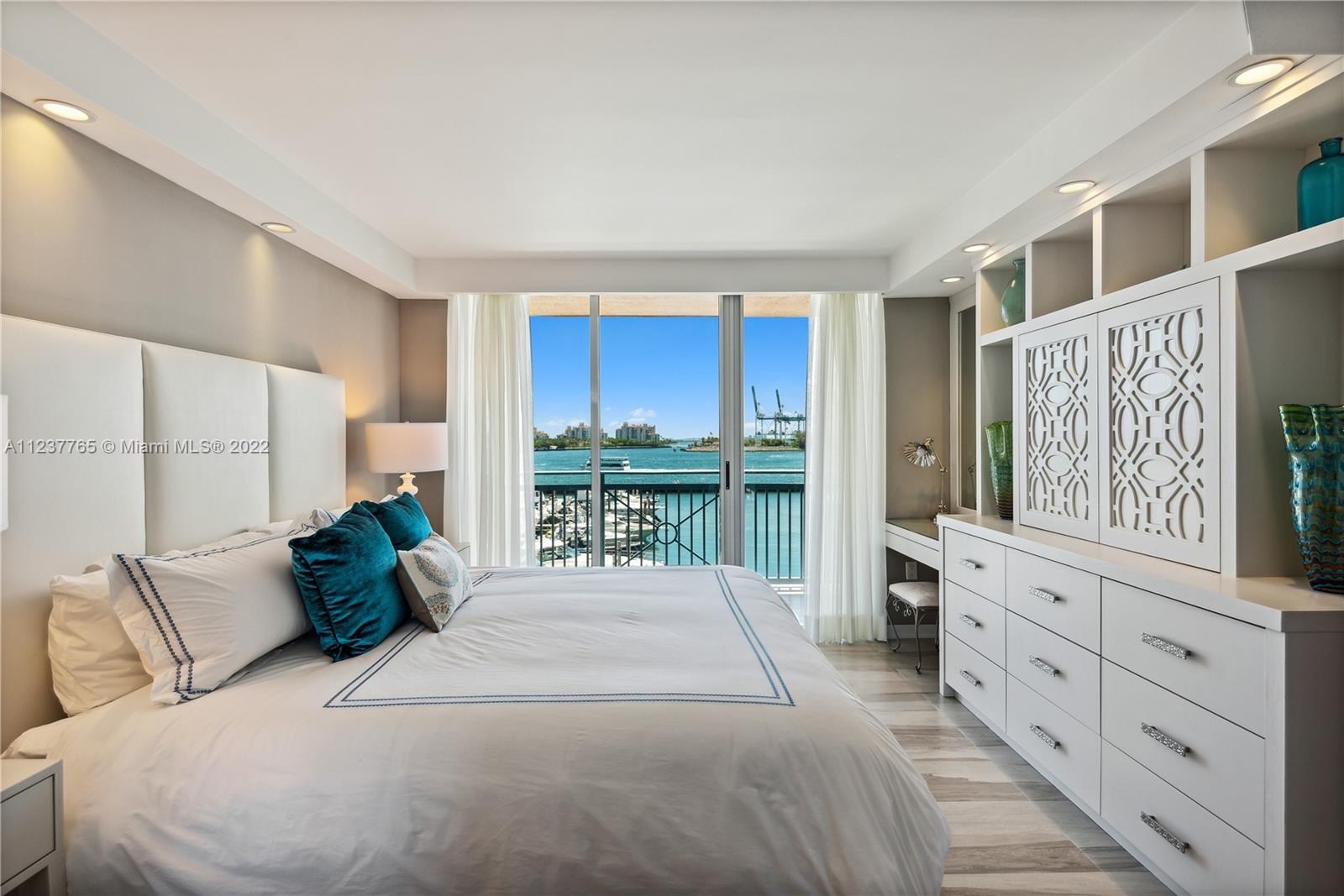 90 Alton Road, Unit TH8 Miami Beach, FL 33139 - Photo 9 of 25 a bedroom with a large bed and a large window