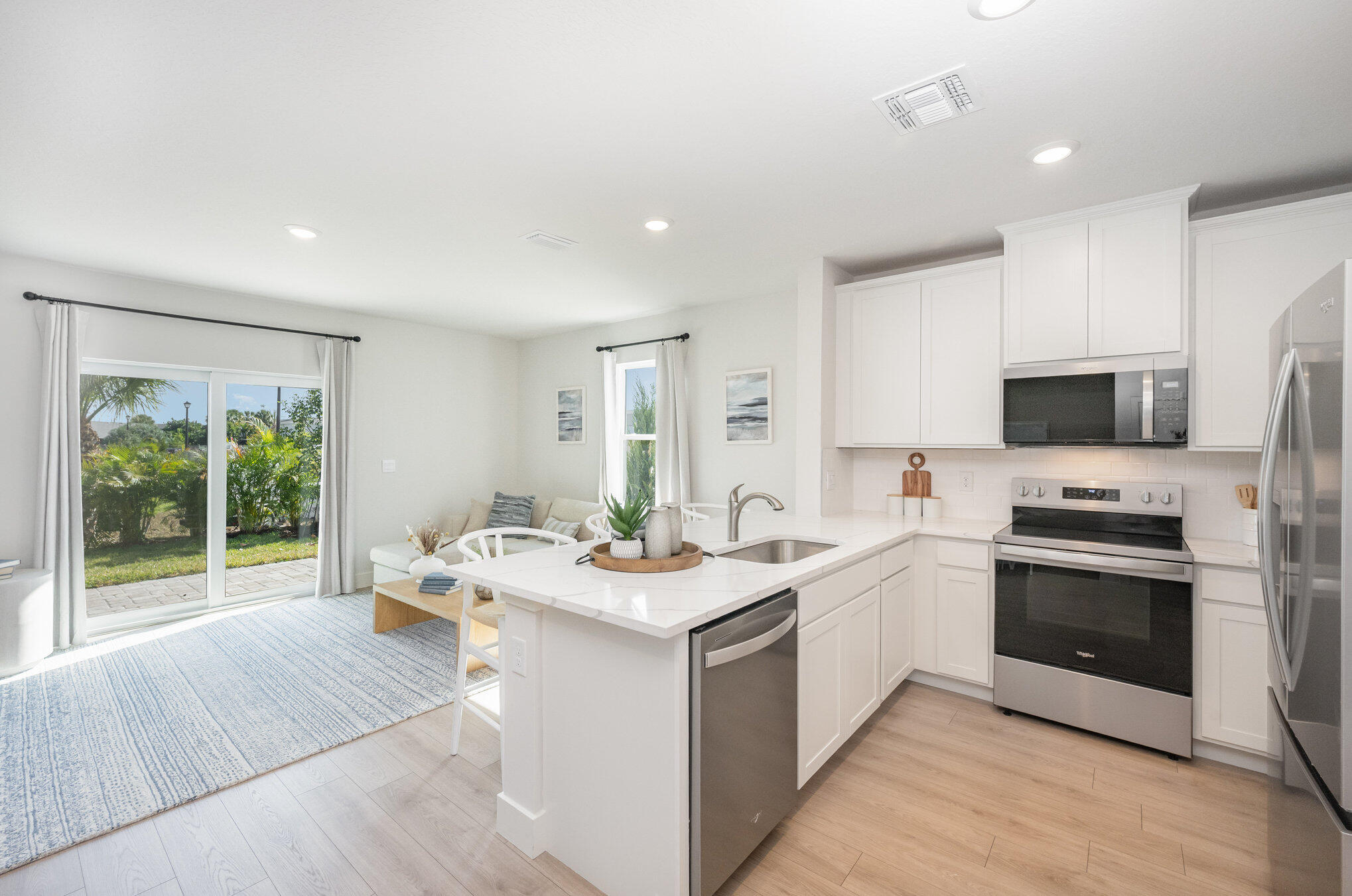 8164 Cobblestone Drive Fort Pierce, FL 34945 - Photo 2 of 17 a kitchen with a sink stove top oven and refrigerator