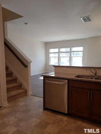 a kitchen with granite countertop a stove and a sink