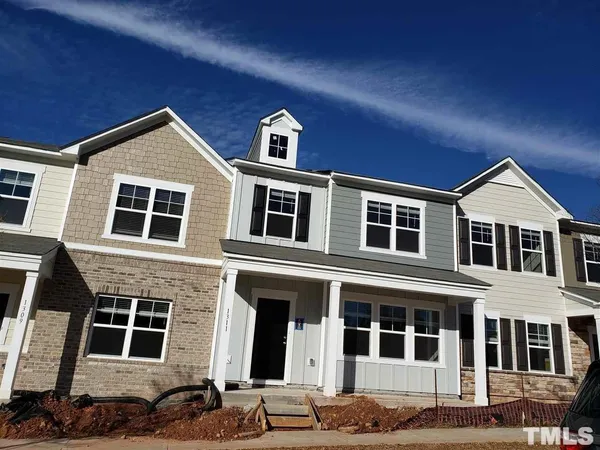 a front view of a house with many windows