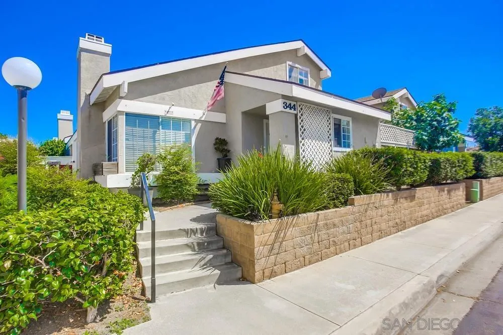 344 Riverview Way Oceanside, CA 92057 - Photo 1 of 41 a front view of a house with a garden