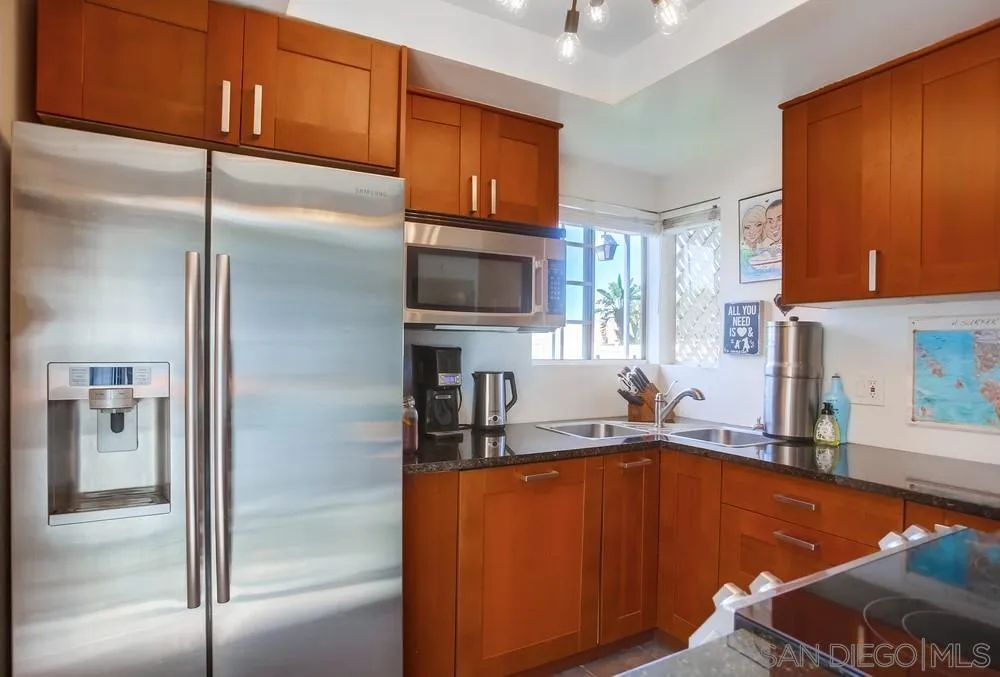 344 Riverview Way Oceanside, CA 92057 - Photo 11 of 41 a kitchen with stainless steel appliances granite countertop a refrigerator and a sink
